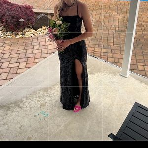 Black open back prom dress with slit.